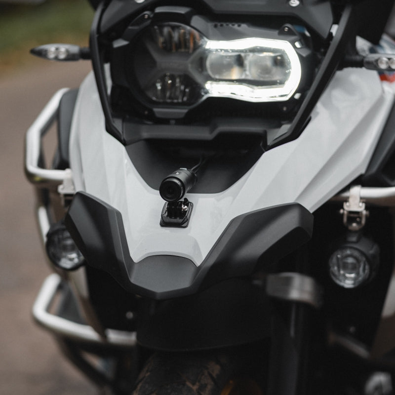 INNOVV K6 motorcycle dashcam front camera lens mounted on an adventure motorcycle beak for security