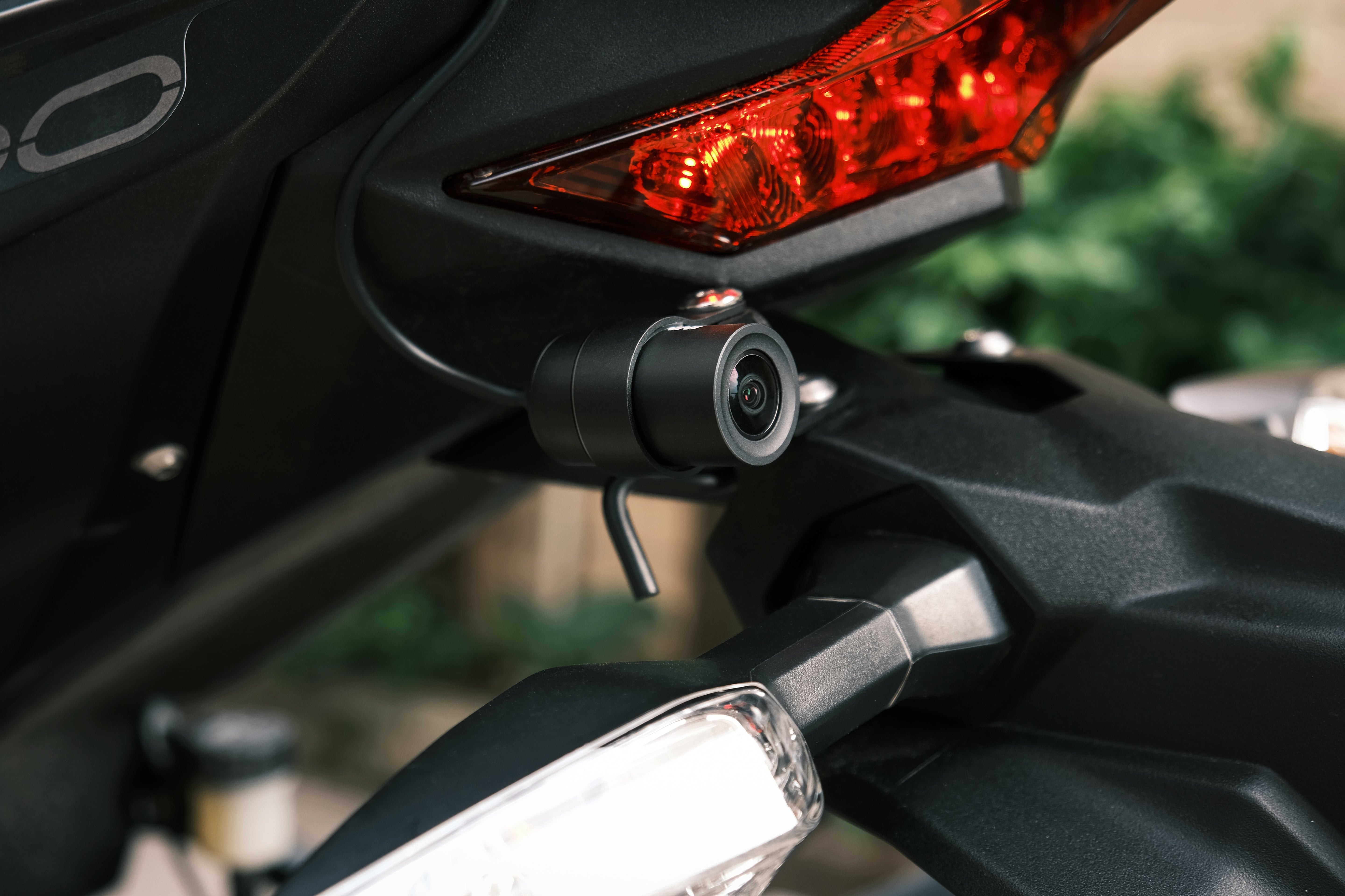 Rider installing the INNOVV K7 motorcycle dash cam on a Motocycle