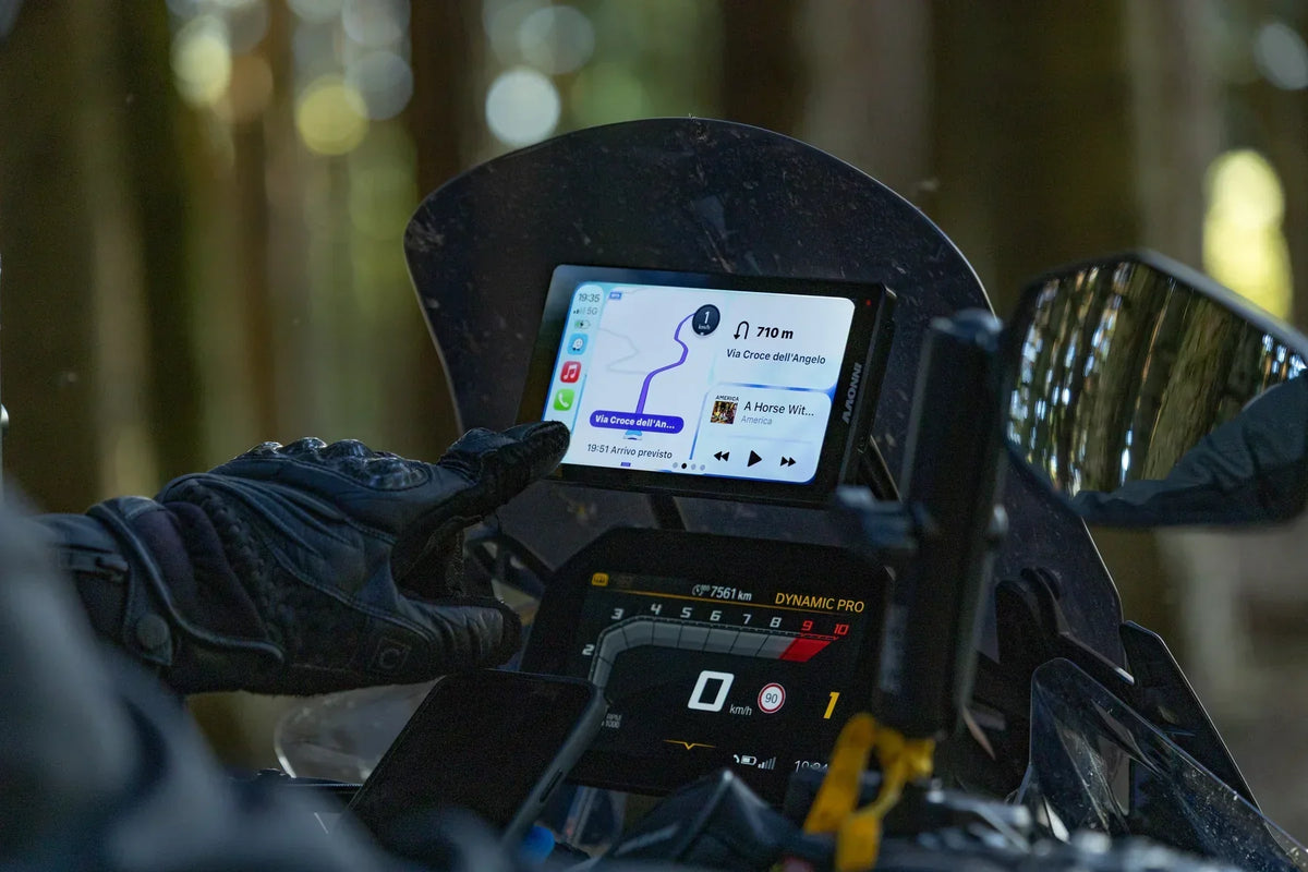 Rider using a touchscreen motorcycle display with compatible riding gloves