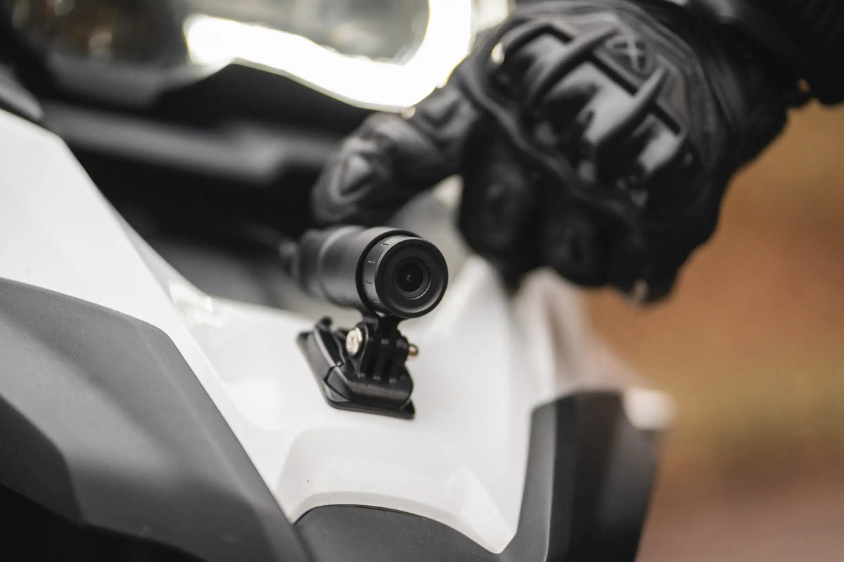 INNOVV K7 dual-channel motorcycle dashcam components: waterproof DVR unit, rear camera mount, and handlebar remote control