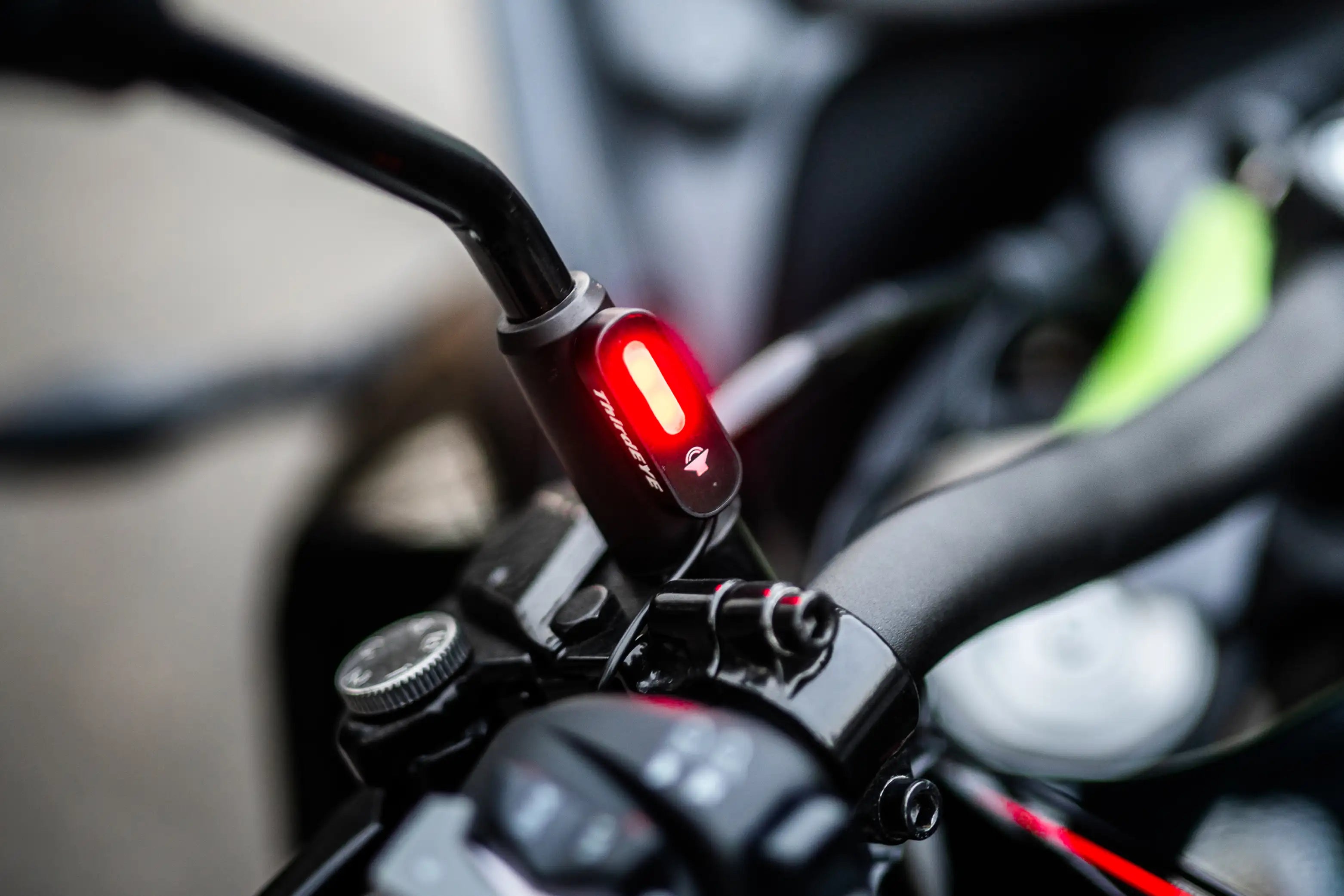Motorcycle radar blind spot indicator light mounted on handlebar mirror stem